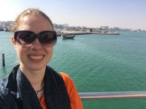 girl standing on a railing in Doha