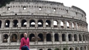 Girl sitting in front of the colosseum